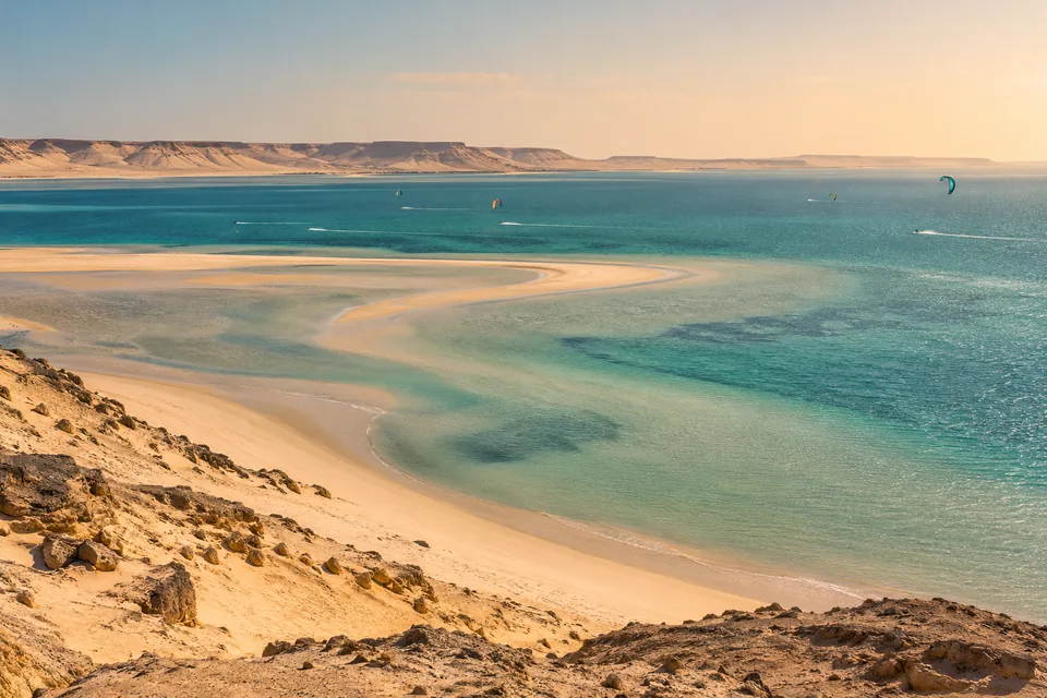 Dakhla-inspired desert and lagoon illustration with distant kites